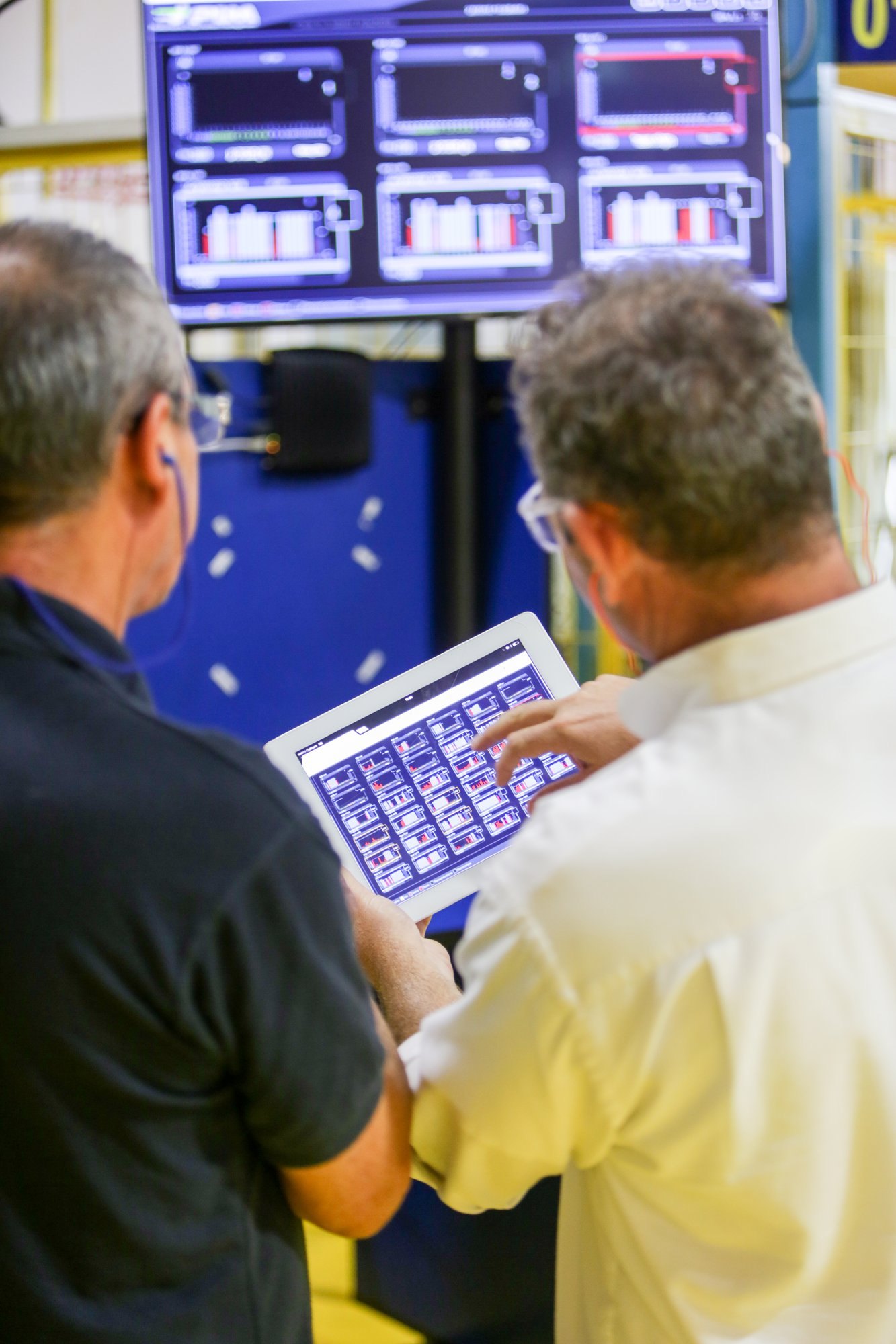 Two managers reviewing VF AI analysis on a tablet